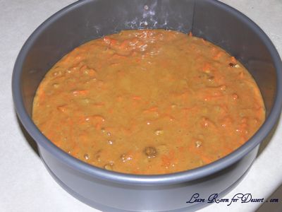 Mix in the grated carrot and walnuts and pour into prepared pan