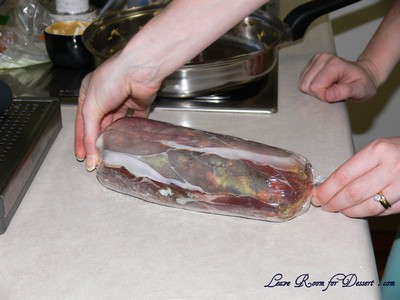 Roll the proscuitto up around the beef fillet and twist ends to seal - place in fridge
