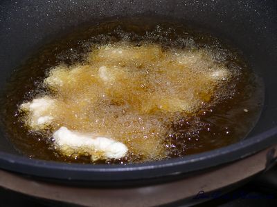 Deep fry the battered chicken in hot oil