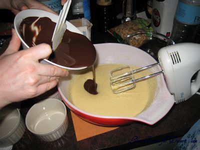 Mix the slightly cooled chocolate into the egg mixture