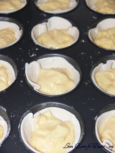 Portuguese_Custard_Tarts_uncooked Rolled pastry slices in muffin tin with cooled custard