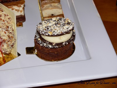 “W” - Chocolate pop rock & popcorn disc, vanilla almond chantilly, dulce de leche, flourless chocolate sponge, almond feulletine.