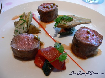 Lamb - basil scented fillet with red capsicum, baby artichokes and green olive and lavender sauce